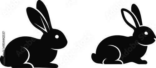 Two black silhouette rabbits on white background