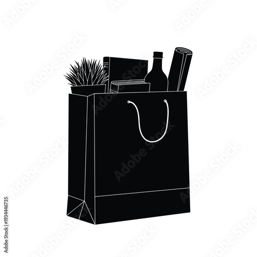 Black shopping bag filled with books, a plant, a bottle, and a rolled item