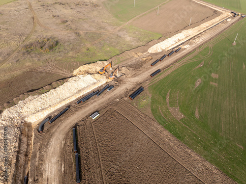 Aerial view of gas and oil pipeline construction. Pipes welded together. Big pipeline is under construction. Energy and fuel transportation industry concept