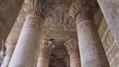 Egypt. Esna temple hypostyle hall with massive painted columns and colorful hieroglyphic reliefs on ceiling in Egypt, ancient Roman-era architecture with preserved pigments and carvings.