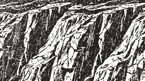Rough textured rock cliff face sharp jagged stone surface with deep crevices and fissures