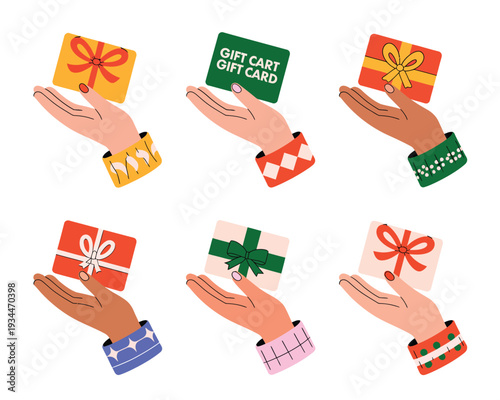 Hands holding various gift cards and wrapped presents for the holidays.