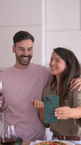 Happy couple making a video call together at home