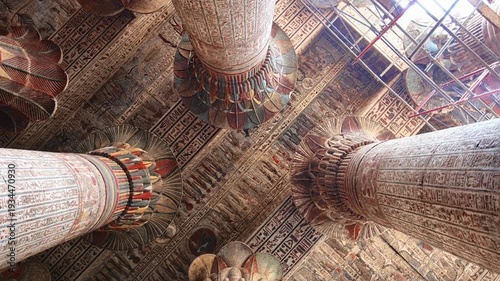 Egypt. Esna temple hypostyle hall with massive painted columns and colorful hieroglyphic reliefs on ceiling in Egypt, ancient Roman-era architecture with preserved pigments and carvings.