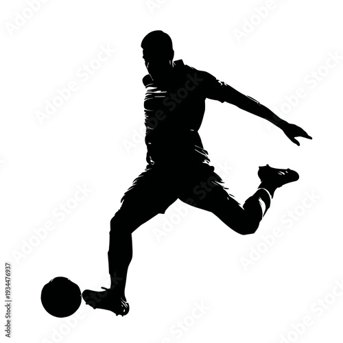 Silhouette of a soccer player kicking the ball with great force and precision.
