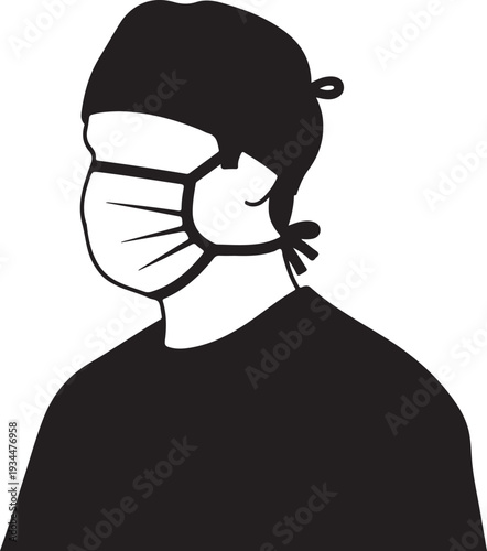 Person wearing a protective mask and head covering in a medical setting