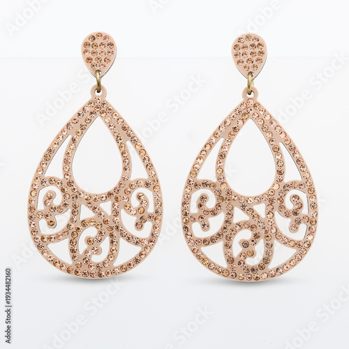 Tableau sur toile A pair of rose gold teardrop earrings adorned with sparkling crystals on a white