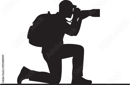 Silhouette of a photographer crouching while taking a picture with a camera