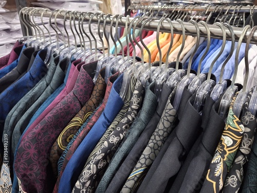 hanging rack containing various kinds of men's batik shirts with various motifs and colors.