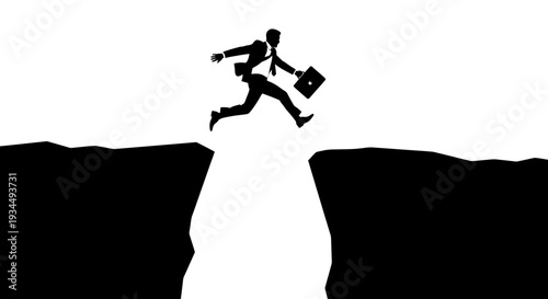Businessman jumping over a deep chasm.