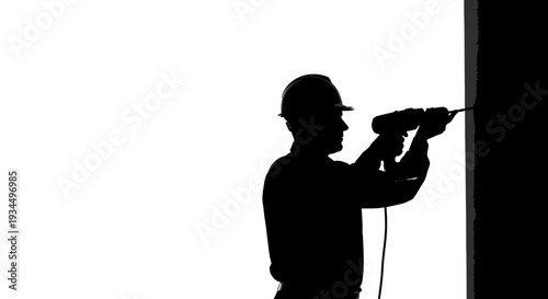 Man wearing hard hat drilling.