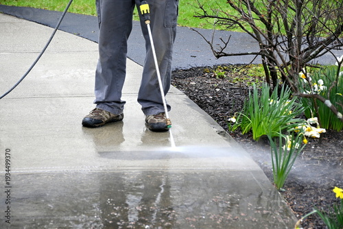 man cleans path. Pearson uses power washer, spring cleaning. 