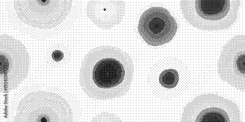 Black and white illustration of various sized dark circles on a with subtle texture