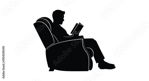 A relaxed man is deeply engrossed in reading a book while seated comfortably in an armchair silhouette
