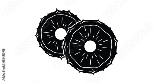 Two circular slices of citrus fruit likely oranges or lemons are displayed in a striking black silhouette