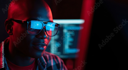Portrait of man wearing glowing glasses in dark room