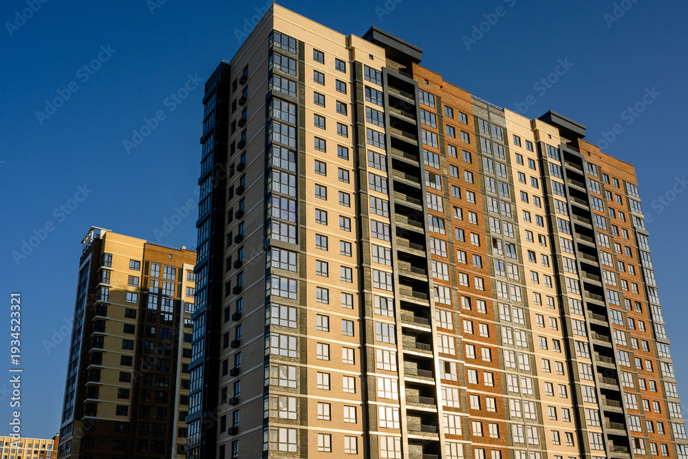 Fototapeta premium Modern residential apartment buildings against clear blue sky