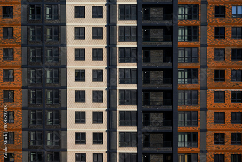 Modern apartment building facade with contrasting brick and panel designs