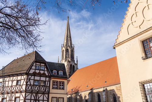 View of the city church tower and a half-timbered house at the market square in Merseburg, Germany, with a partial view of the Old Town Hall.