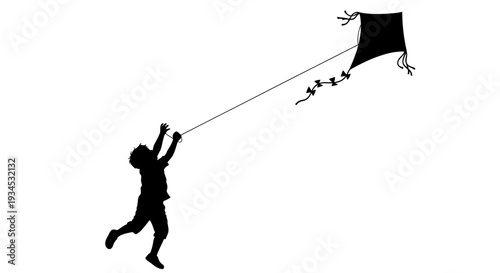 Silhouette of a child flying kite.