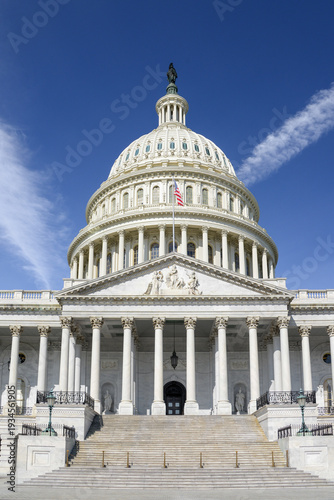Washington, DC, USA - March 21st 2024 - A closeup of the Capitol building dome in Washington, DC, with the American flag on a nice day.