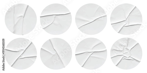 Eight crumpled white round stickers with creases and wrinkles, isolated on a white background, perfect for a mockup or graphic element