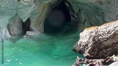 Discover the ethereal Marble Caves of Patagonia. Pristine azure water gently laps against intricately carved marble walls. A natural masterpiece under the sun.