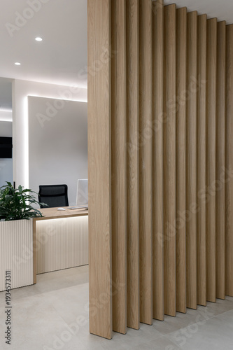 Modern office reception area with wooden partition and minimalist design