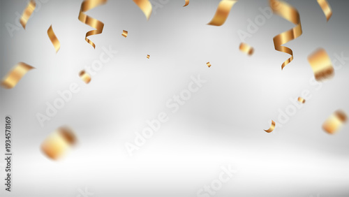 Festive gold streamers fall against a soft gray background, creating a celebratory mood.