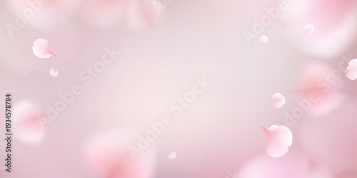 Soft pink flower petals gently falling against a dreamy pastel background.