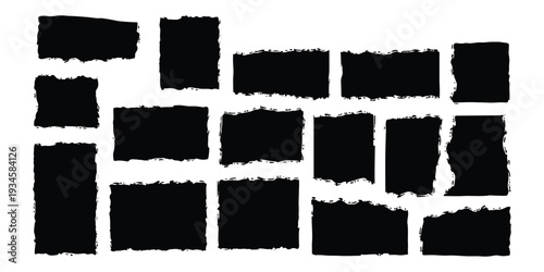 A collection of black abstract shapes with rough, torn edges resembling pieces of ripped paper