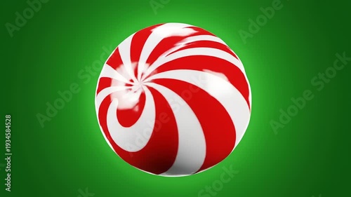 Rotating Red and White Peppermint Candy on Green.