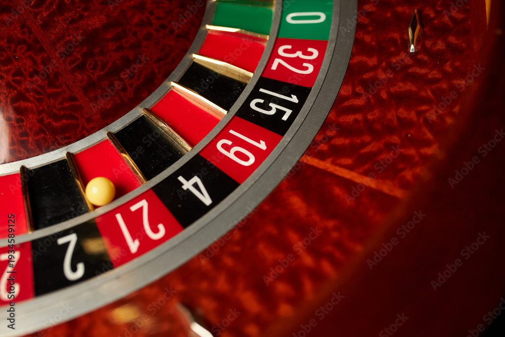 Obraz premium Casino theme, betting, online casino. image of red color casino roulette, poker game. roulette wheel. online casino, bets, winnings. Luxury roulette. close-up image