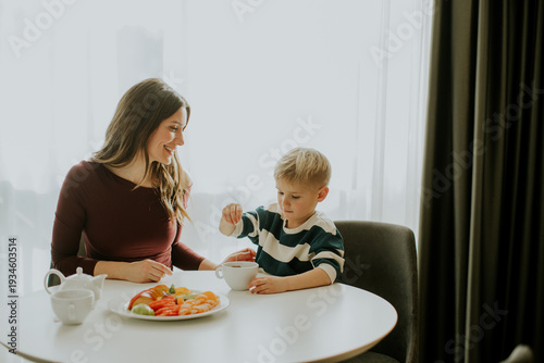 Mother and son enjoy breakf...
