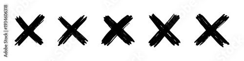 Set of five hand-drawn black grunge X marks or cross symbols isolated on a white background. Hand painted ink brush stroke design elements.