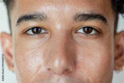 Two people hanging on massless rope over frictionless pulley on cliff showing uniform tension