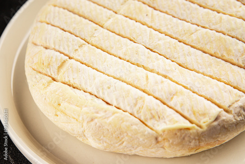 Soft cheese Camembert, Brie, or Coulommiers cheese head tasty snack fresh gourmet food background on the table rustic food top view copy space marketing concept photo