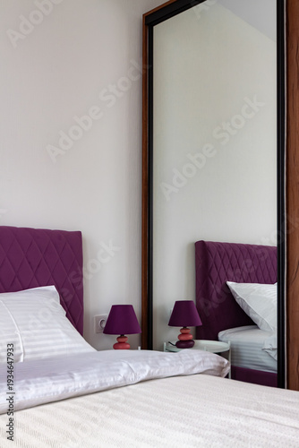 Modern Bedroom Interior with Mirror and Purple Headboard
