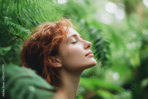 Woman with red hair enjoying nature in a lush green forest