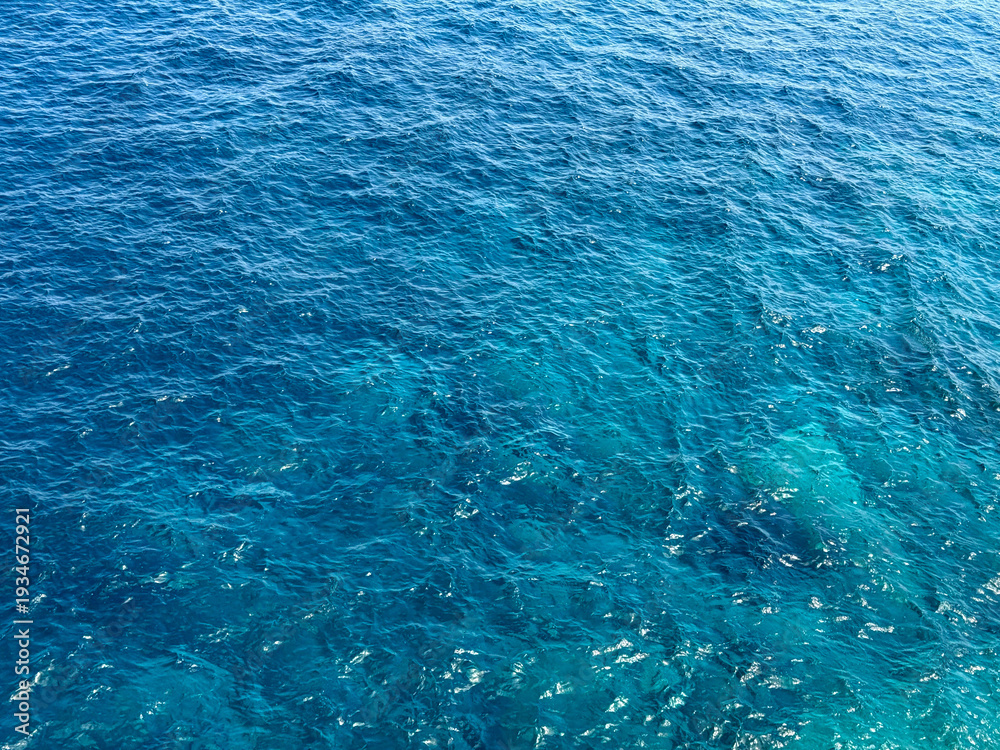 Obraz premium Ocean blue waves calm surface background.