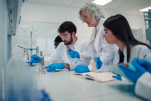 Photography Science professor teaching students during a laboratory experiment