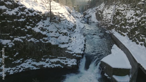 Aerial drone clip over and evergreen forest and river in the American West.