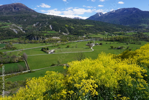 view from embrun, southern alps, france perched on a cliff by serre-ponçon lake in the spring on the valley and mountains