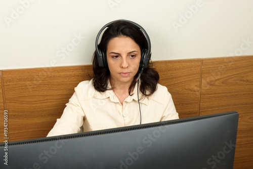 Young professional woman multitasking on her phone and computers