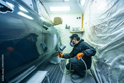 Schilderij op canvas Auto body mechanic spraying car in paint shop