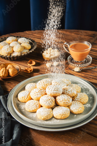 Cookies for celebration of El Fitr Islamic Feast( The Feast that comes after Ramadan).Sprinkling powdered sugar on Kahk (Eid Al- Fitr cookies).