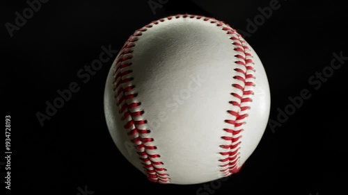 Rotating White Baseball Ball on Black Background . Filmed on High Speed Cinematic Camera at 1000 fps