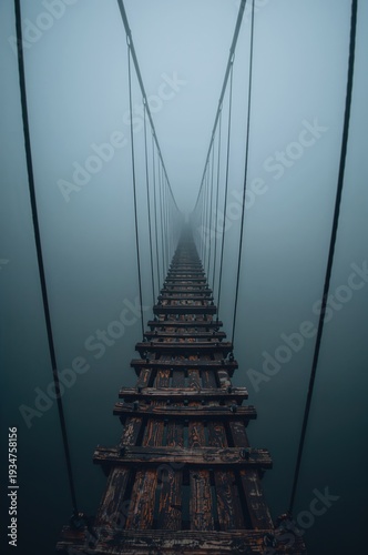 Wallpaper Mural Foggy suspension bridge rises overhead as rusted cables vanish into deep mysterious abyss Torontodigital.ca