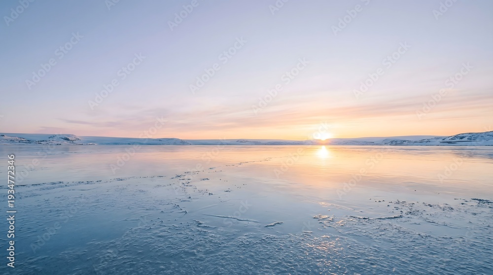 Fototapeta premium Serene sunset over calm frozen lake with ice and snow at dawn
