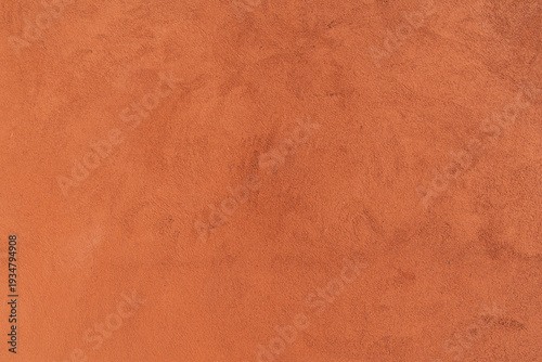 Textured orange plaster wall surface close up interior finish detail